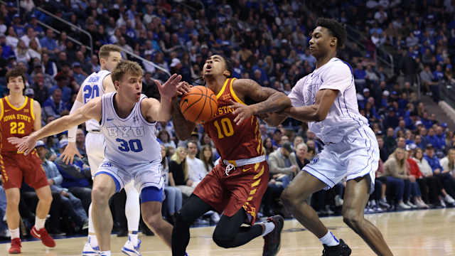 Jan 16, 2024; Provo, Utah, USA; Iowa State Cyclones guard Keshon Gilbert (10) goes to the basket between Brigham Young Cougars guard Dallin Hall (30) and guard Jaxson Robinson (2) during the second half at Marriott Center. Mandatory Credit: Rob Gray-USA TODAY Sports
